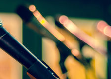 a row of microphones on a stage