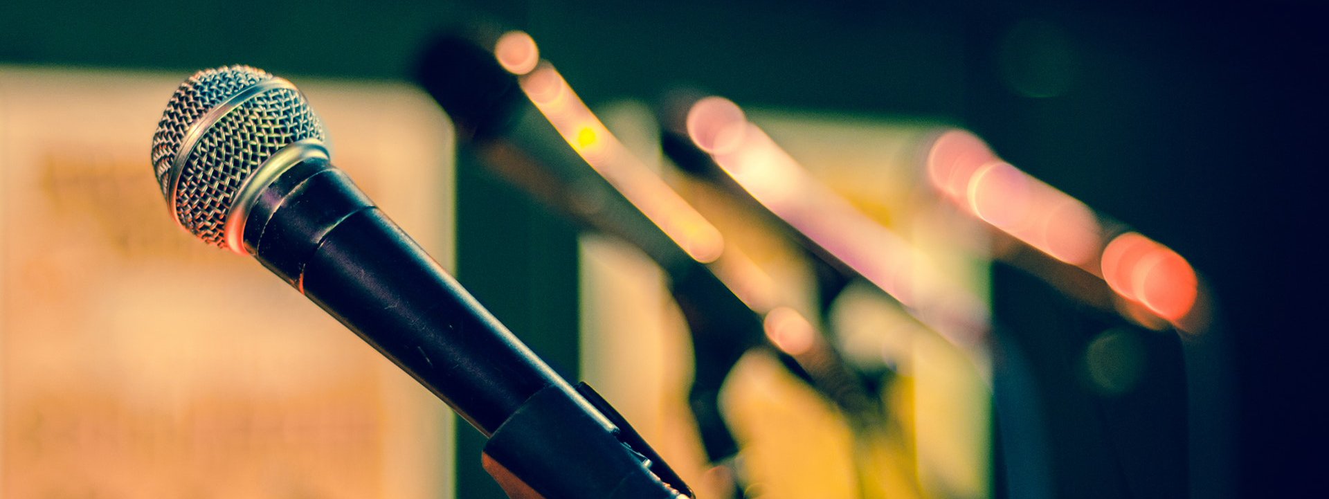 a row of microphones on a stage
