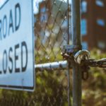 chained gate fence road closed sign
