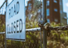 chained gate fence road closed sign