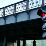red traffic light in front of a bridge