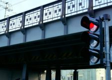 red traffic light in front of a bridge