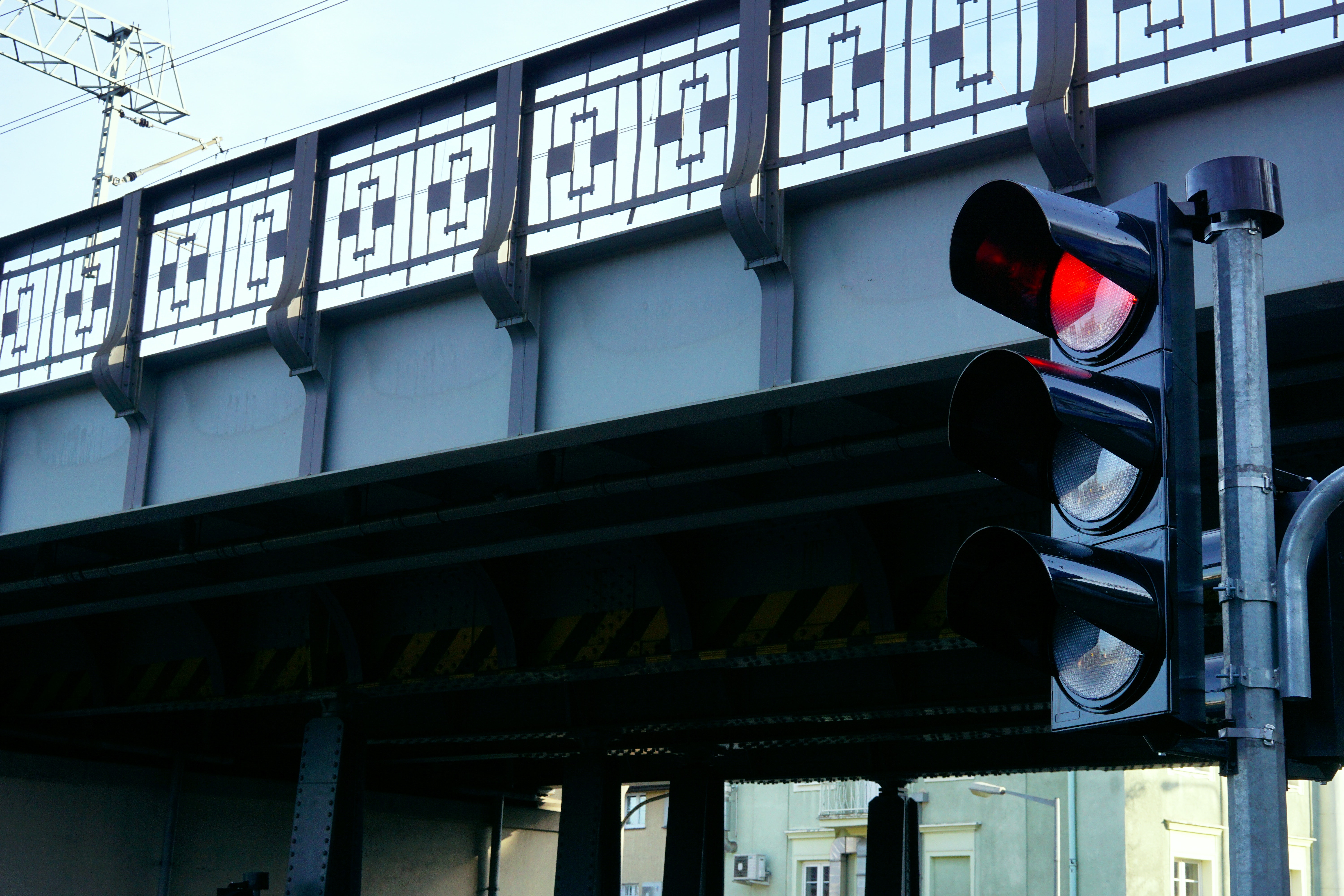 red traffic light in front of a bridge
