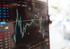 A monitor displaying a financial graph