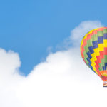 A hot air balloon in front of a blue sky