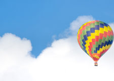 A hot air balloon in front of a blue sky