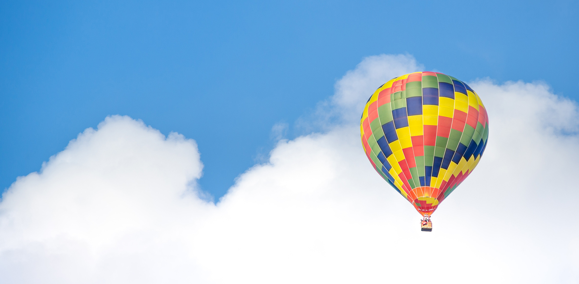 A hot air balloon in front of a blue sky