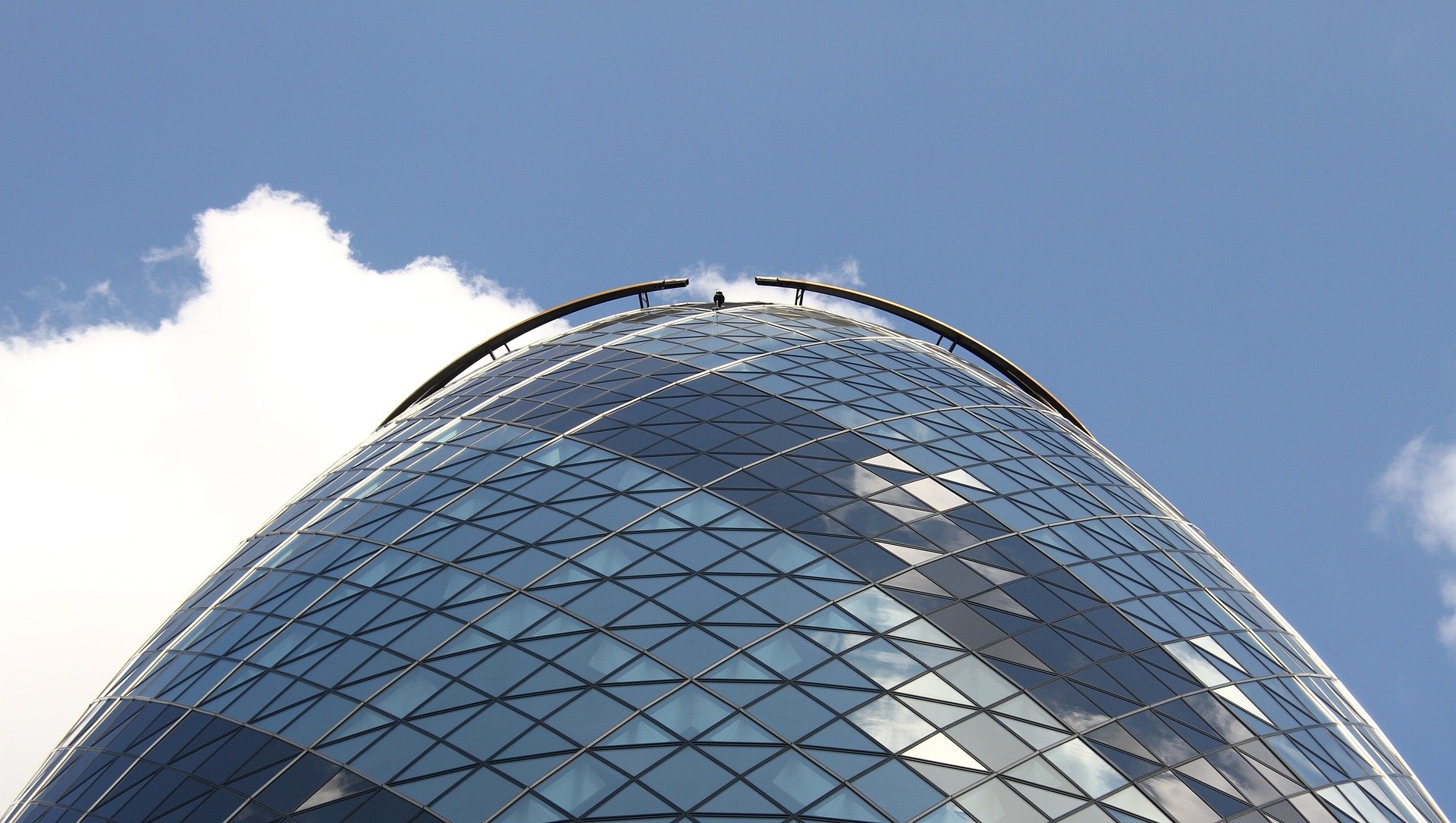 The Gherkin building, bright blue sky