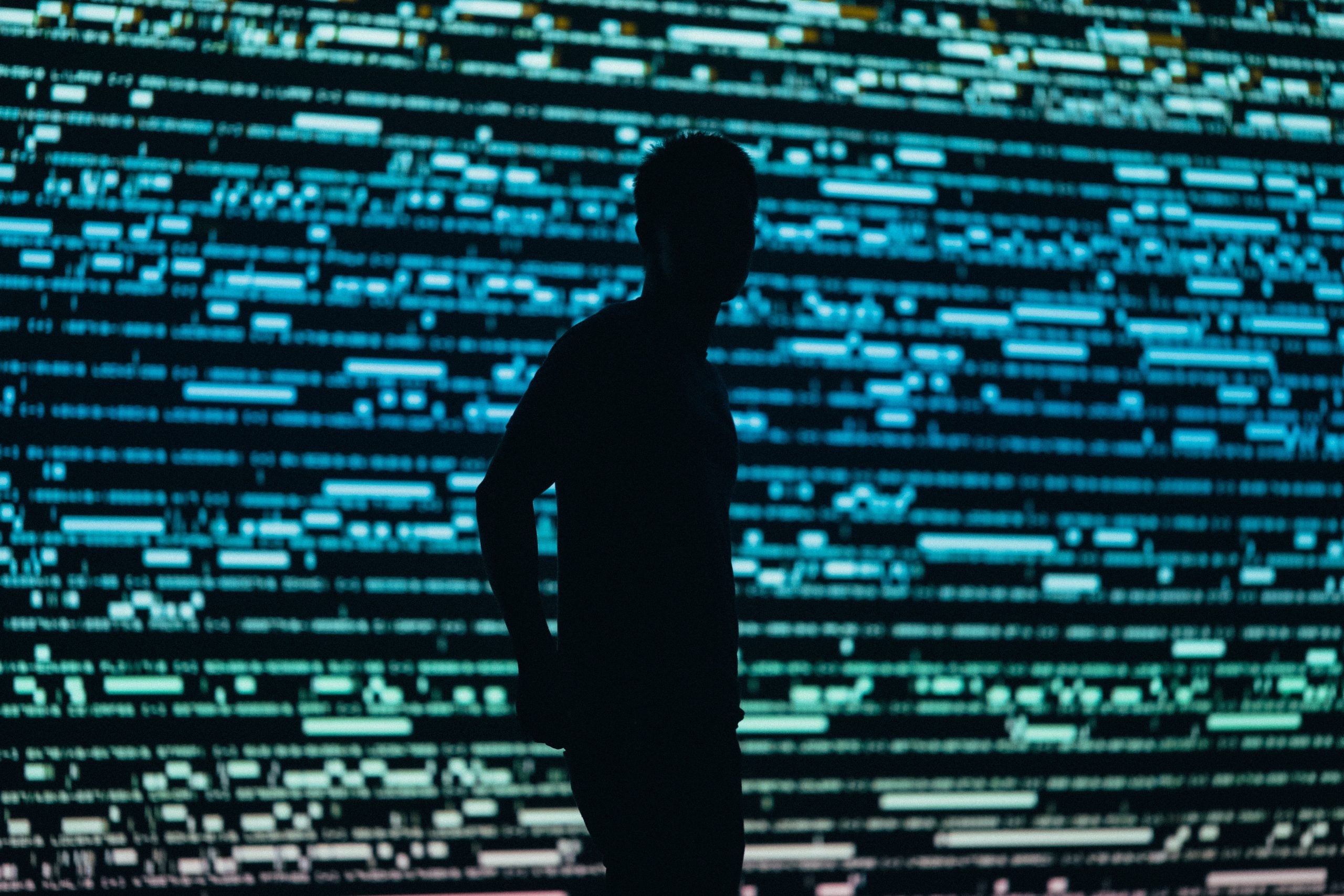 Silhouette of a person in front of panel lights