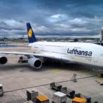 A parked Lufthansa air plane on a cloudy day