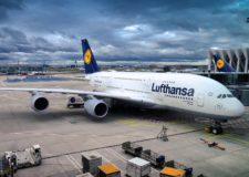 A parked Lufthansa air plane on a cloudy day